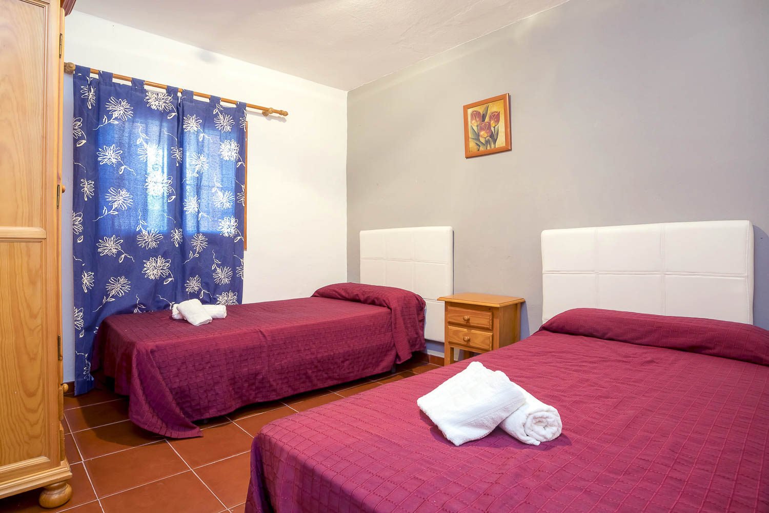 Double and a single bed in a room of a rental house in Ibiza